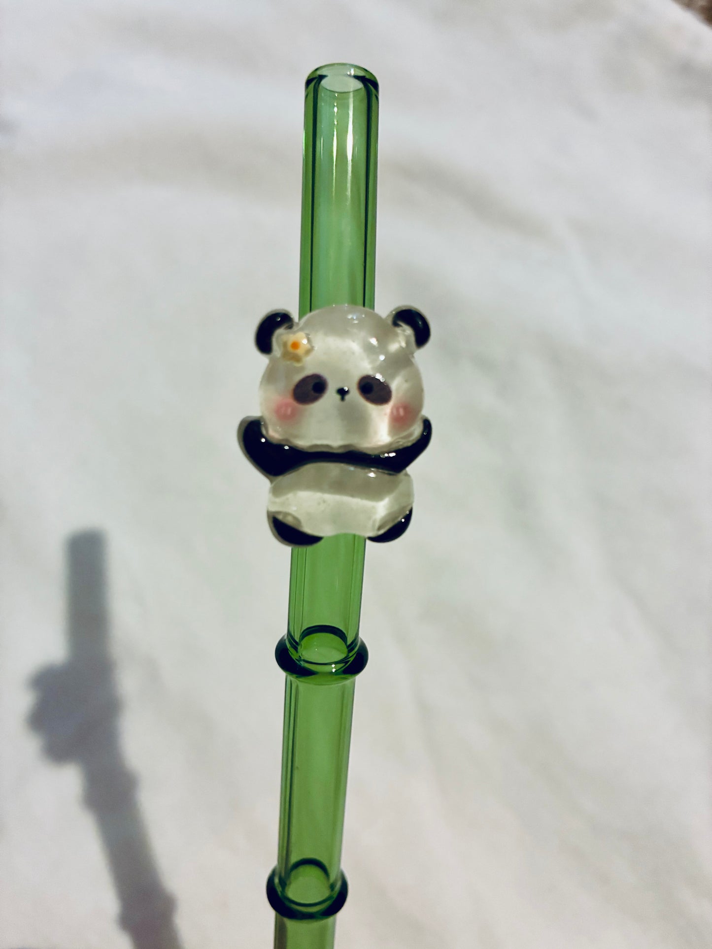 Glass panda on bamboo straw