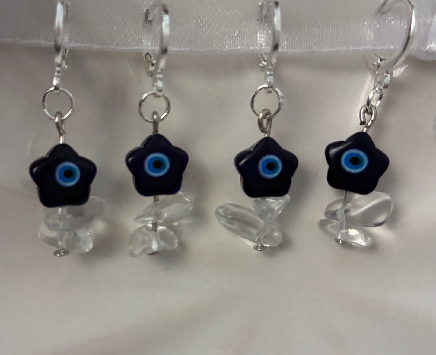 Evil eye flower huggie earrings